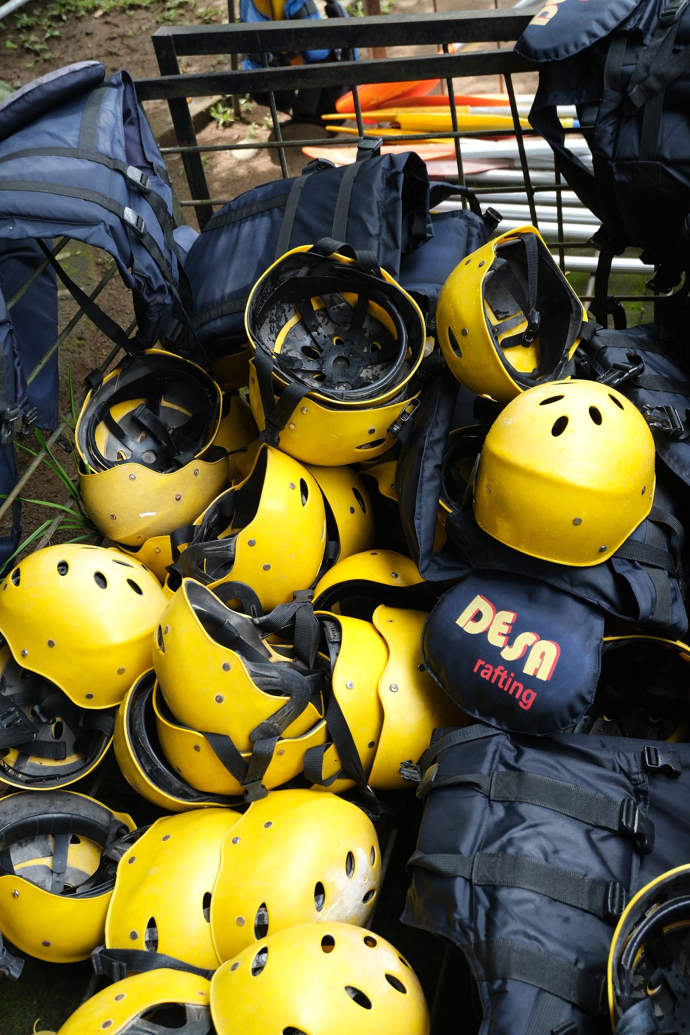 Rows of yellow rafting helmets stacked and ready for guests